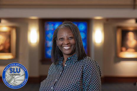 A headshot of Christa Jackson, Ph.D., and the SLU ˻ֱ Institute Fellows induction coin.